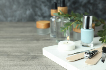 Obraz na płótnie Canvas Concept of nail care with manicure accessories on gray wooden table