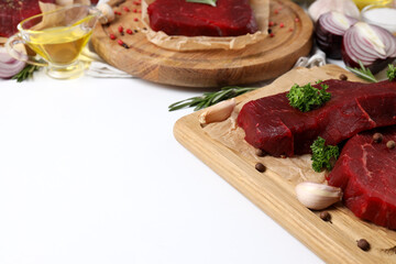 Concept of tasty food with raw beef steaks on white background