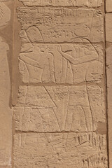 Relief details and Egyptian hieroglyphs at Karnak temple complex in Luxor