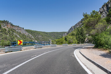 A road with sharp turns in the mountains. Serpentine highway. Skradin, Croatia.