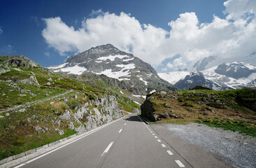 Naklejka premium Asphalt road in Alp mountains. Road trip concept. Beautiful landscape.