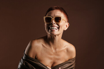 Obraz premium Senior shirtless woman smiling while posing on camera