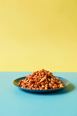 Processed pea nuts in a bowl on color background 