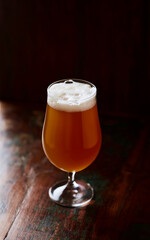 Glass of beer on dark background. Copy space.