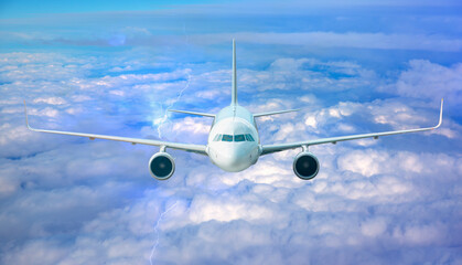 White passenger airplane flying in the sky amazing clouds in the background - Travel by air transport