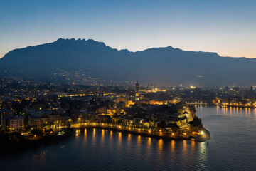 Lecco city aerial shot before the sunrise with Resegone mount on the background.