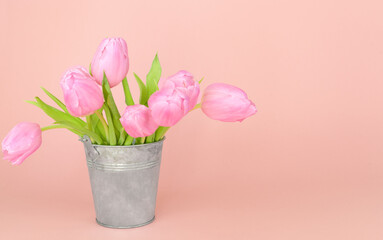 Bouquet of pink tulips in a rustic vase. Background for postcard