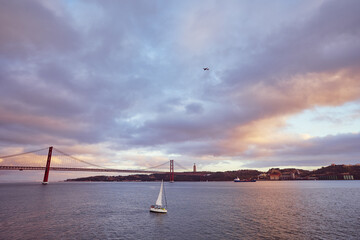 Beautiful landscape with suspension 25 April bridge bridge over the Tagus river in Lisbon, Portugal.