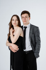  young couple in suits on white background.