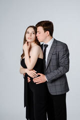  young couple in suits on white background.