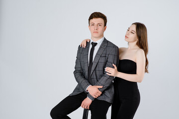  young couple in suits on white background.