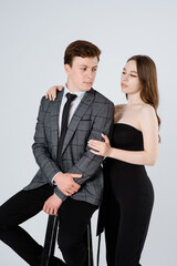  young couple in suits on white background.