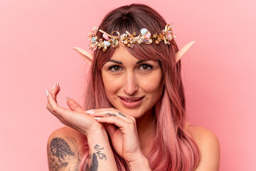 Young caucasian elf woman isolated on pink background