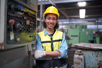 Female apprentice in metal working factory, Portrait of working female industry technical worker or engineer woman working in an industrial manufacturing factory company.