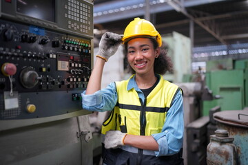 Factory Female Industrial Engineer Works in metal working factory, Inside the Heavy Industry. Portrait of working female industry technical worker or engineer woman working in an industrial.