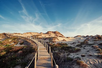 Fototapete Rund Naturpark Wooden pedestrian walkway through Sintra-Cascais natural park. Wild sandy landscape, with part of Cresmina Dunes. Beautiful scenery in Portugal.  © luengo_ua