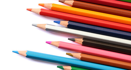 Colored pencils on white background, copy space