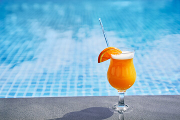 Relaxing weekend. The glass of cocktail on the poolside.