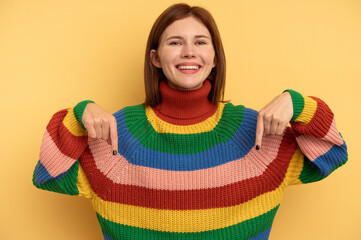 Young English woman isolated on yellow background points down with fingers, positive feeling.