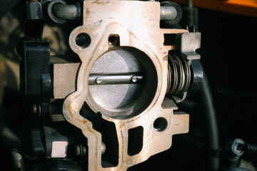 Car repair. Cleaning the throttle valve of the injection engine. Close up old throttle with traces...