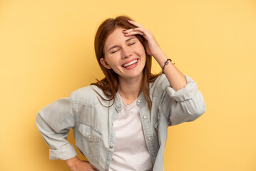 Fototapeta premium Young English woman isolated on yellow background joyful laughing a lot. Happiness concept.