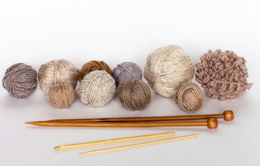 Needlework and DIY concept. Clews of different types of wool yarn for hand knitting and wooden...