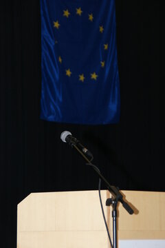 The EU flag above a podium in Budapest before a political discussion.