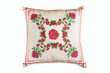 Cross-stitch embroidery in the form of roses on a white linen pillow.