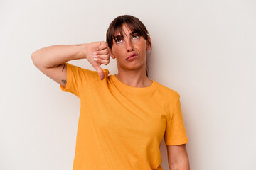 Young Argentinian woman isolated on white background showing a dislike gesture, thumbs down....
