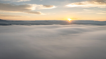 An aerial view of beautiful white clouds against a beautiful mountain backdrop. topography of northern Thailand