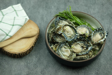 Big fresh asian oysters on plate with side dishes