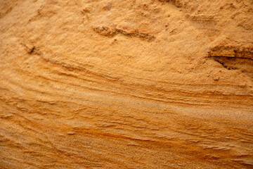 Textural sand, with  relief surface, multi-colored layers and different in size of granules, in outdoor sand career, after mining ore and sand for construction.