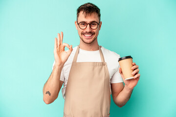 Young store clerk man holding a coffee isolated on blue background cheerful and confident showing...