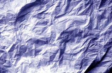 Crumpled white paper background in blue tone.