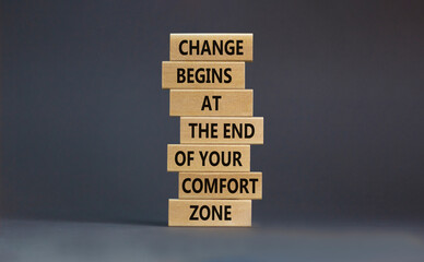 Out from comfort zone symbol. Wooden blocks with words Change begins at the end of your comfort...