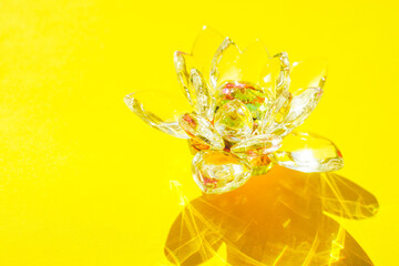 Crystal lotus flower on a yellow sunny table