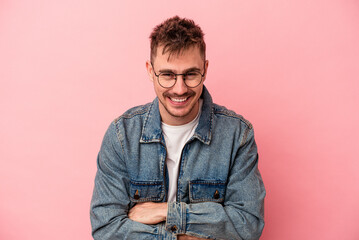 Fototapeta premium Young caucasian man isolated on pink background laughing and having fun.