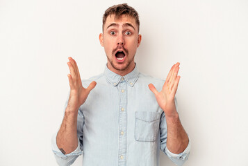 Young caucasian man isolated on white background upset screaming with tense hands.