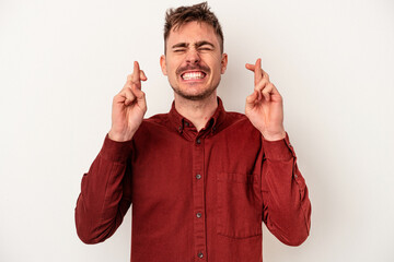 Young caucasian man isolated on white background smiling confident with crossed arms.