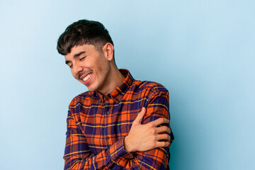 Young mixed race man isolated on blue background laughing and having fun.