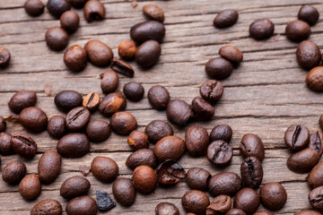 Coffee beans on old wooden floor background..