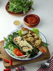 Crispy fried fish served with rice, vegetables and chili