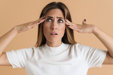 White mid woman rubbing her temples and looking upward