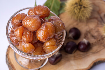 Chestnut dessert and chestnuts on a plate. Traditional delicious Turkish dessert; chestnut candies (Kestane Sekeri)