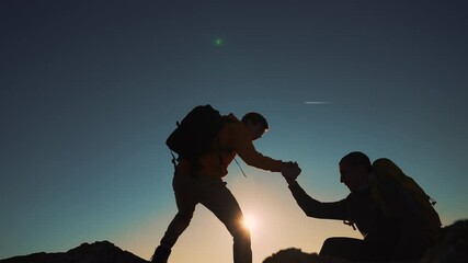 Family team success.Silhouette of group people.Climb to the top of mountain.Helping hand family victory.Teamwork concept.Business handshake.Helping hand of business people.Teamwork is path to success