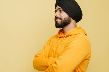 Bearded south asian man wearing turban posing with arms crossed