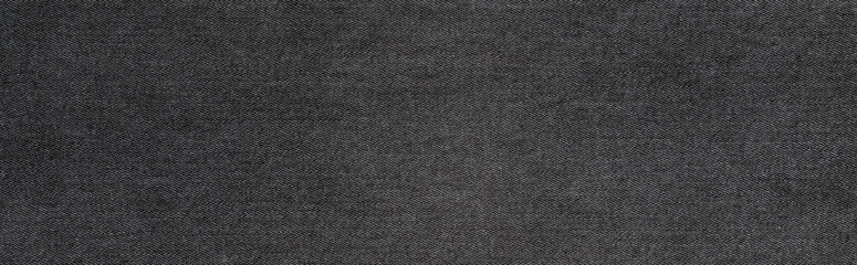 Fototapeta na wymiar texture of black colored jeans denim fabric background 
