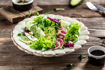 Vegan, detox Buddha bowl with watermelon radish, avocado, lettuce, microgreen, cabbage, cucumber. Top view, flat lay, healthy vegan food