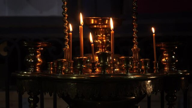 Burning candles in the orthodox church, standing on a pedestal