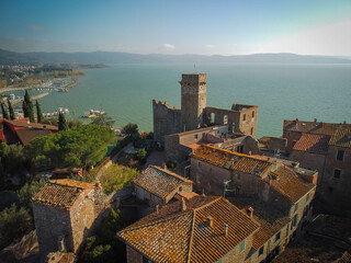 Beautiful aerial view of cityscape with ruins of medieval castle in Passignano town, Italy